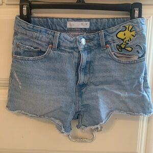 Zara denim shorts embroidered with Peanuts characters.